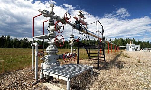A field with pipes and valves on it